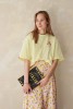 Koszulka oversize unisex z motywem cannoli – pastelowa żółć w roli głównej
